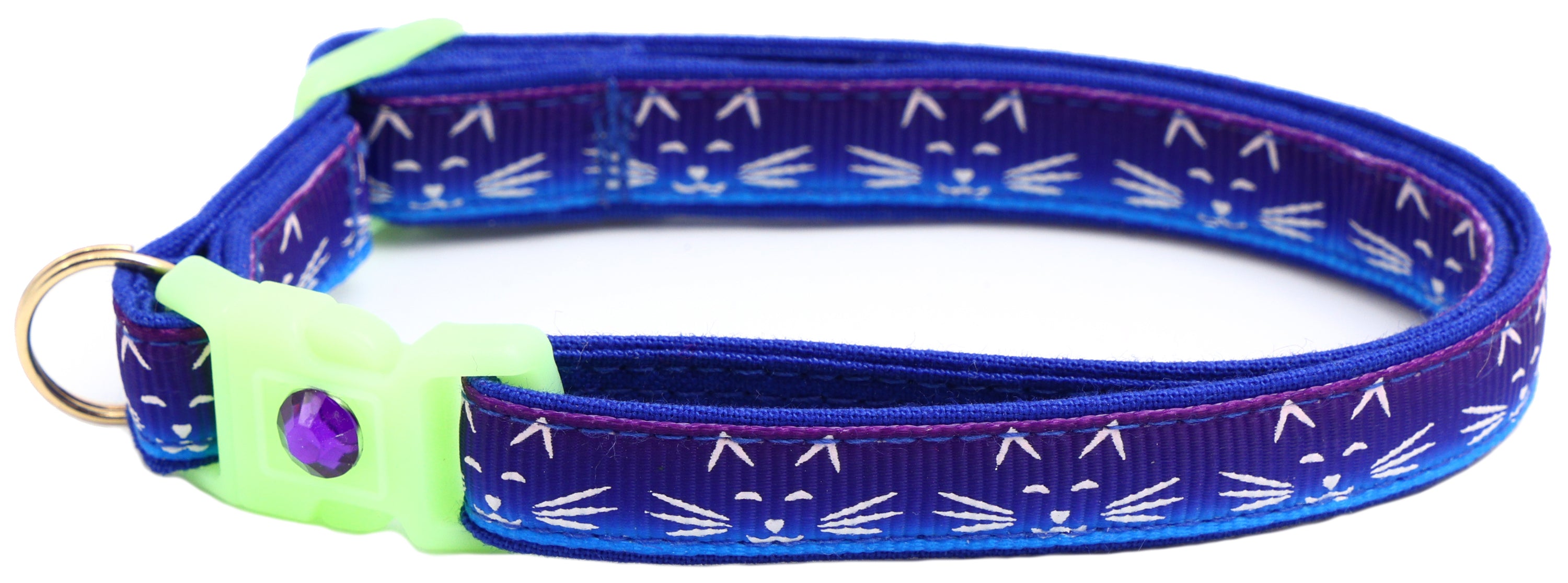 A glowing cat faces breakaway collar made of reinforced cotton, featuring a bell and charm, perfect for nighttime visibility.